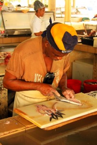Here, a man in Barbados prepares flying fish fillets.