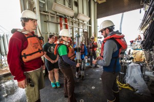 Preparing to process the sediment cores in the ship’s staging bay. Before we extrude (push out of the tube) the sediment, we evaluate the amount of sediment recovered (i.e., the depth the tube penetrated the seafloor) and the condition it is in to distribute among the coring group of scientists based on our individual scientific goals. Photo credit to Robyn Von Swank, instagram: @vonswank.